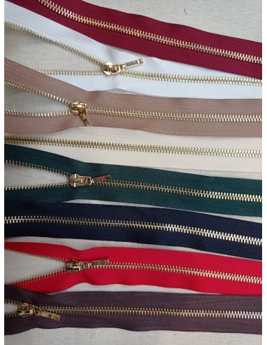 Cremallera con separador metal dorado...